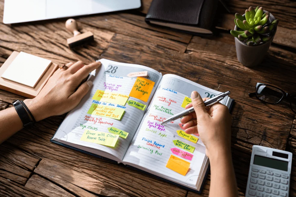A planner sitting on a desk full of appointments